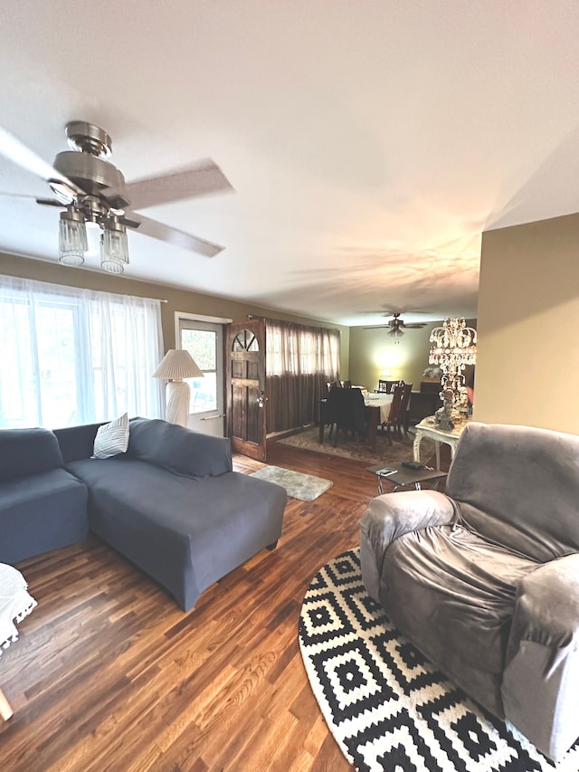 living room featuring dark hardwood / wood-style flooring and ceiling fan