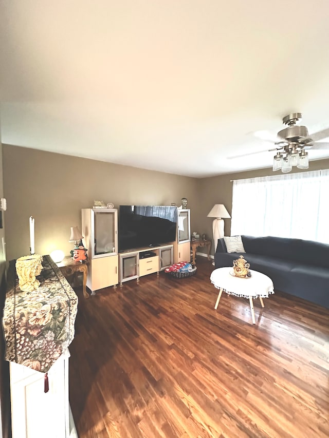 living room featuring wood-type flooring and ceiling fan