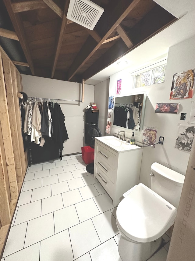 bathroom with tile patterned flooring, vanity, and toilet