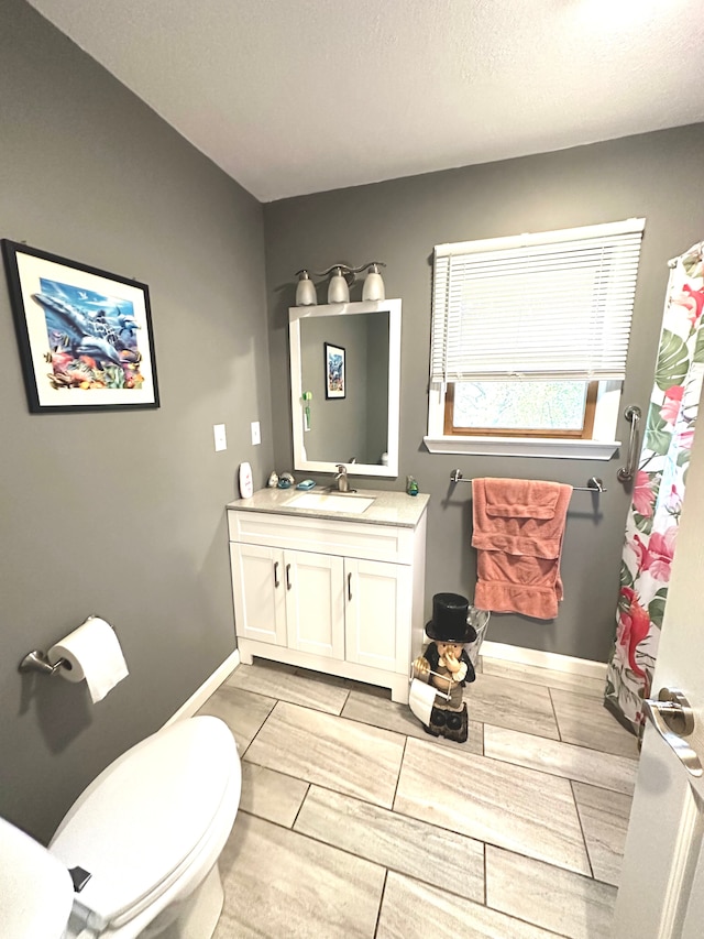 bathroom with vanity, toilet, and wood-type flooring