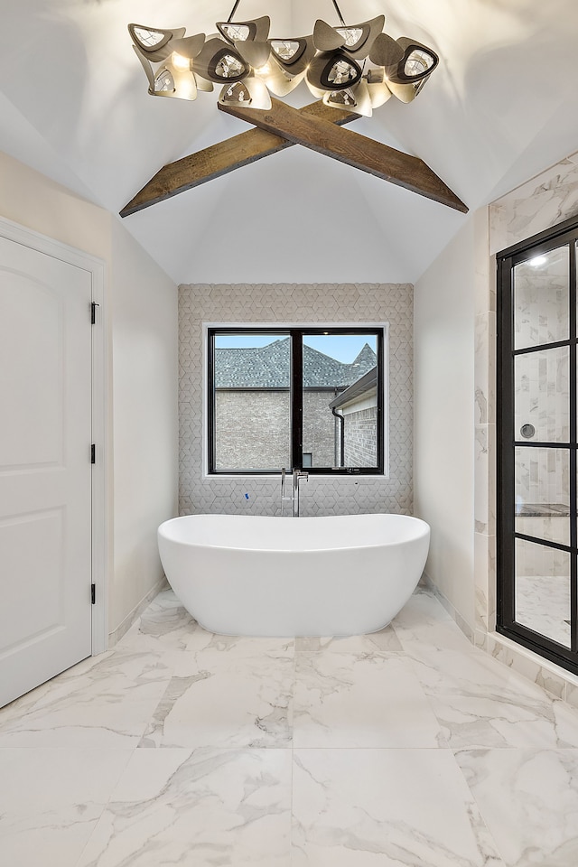 bathroom featuring a bath and vaulted ceiling