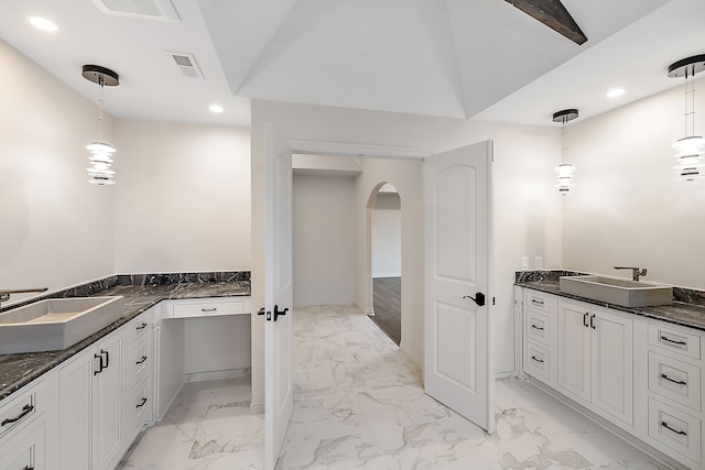 bathroom featuring vanity and vaulted ceiling