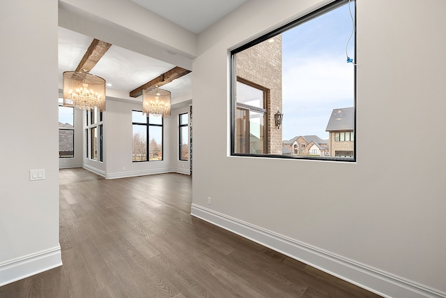 hall with beamed ceiling, hardwood / wood-style floors, and an inviting chandelier