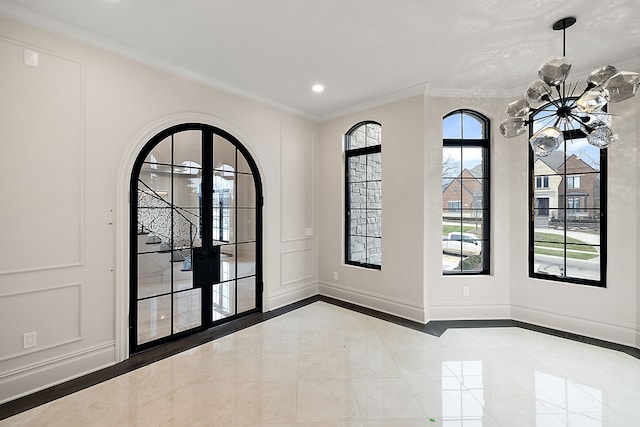 interior space featuring a notable chandelier, crown molding, and french doors