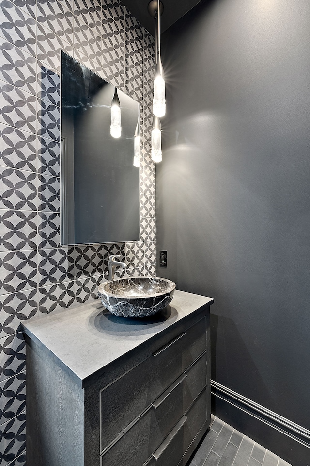 bathroom with decorative backsplash and vanity