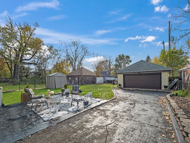 view of patio / terrace with a garage and a storage shed