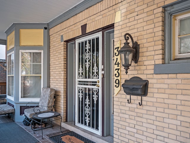 view of exterior entry with covered porch