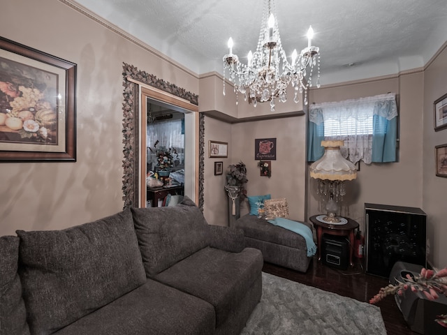 living room with hardwood / wood-style floors, a textured ceiling, and an inviting chandelier