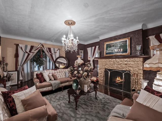 living room with a textured ceiling, a fireplace, and an inviting chandelier