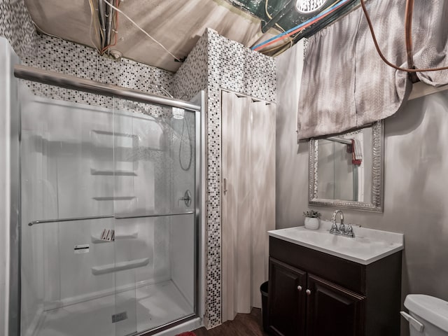 bathroom with vanity, hardwood / wood-style flooring, toilet, and an enclosed shower