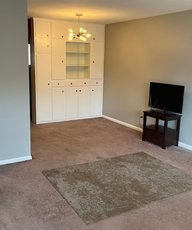 living room featuring carpet and an inviting chandelier