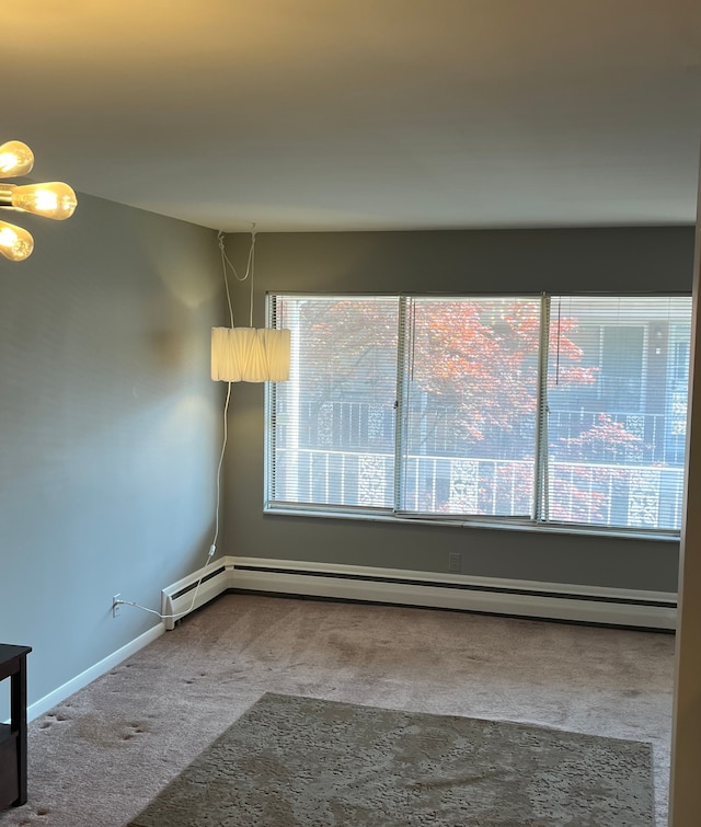 unfurnished room featuring carpet and baseboard heating