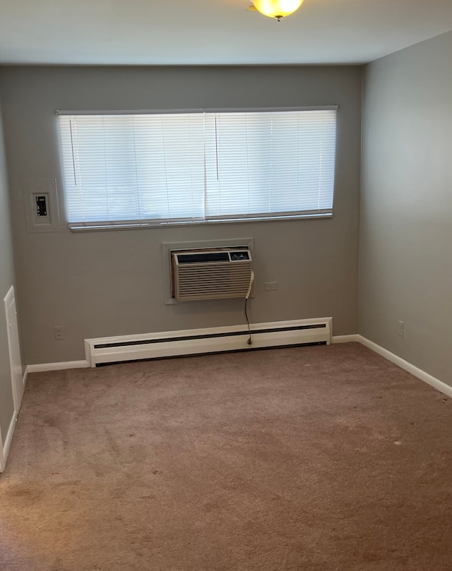 spare room featuring a wall unit AC, light colored carpet, a wealth of natural light, and a baseboard radiator