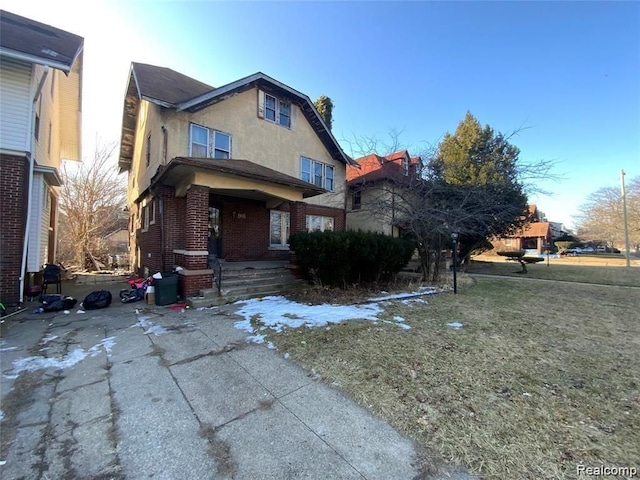 view of front of property with covered porch and a front yard