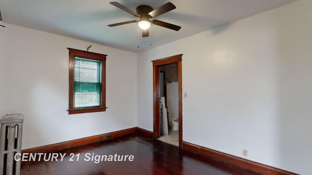 spare room with ceiling fan and dark hardwood / wood-style floors