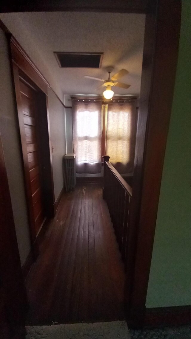2540 S Dreyer Rd, Au Gres, MI 48703 - hallway featuring hardwood / wood-style flooring, an upstairs landing, and baseboards