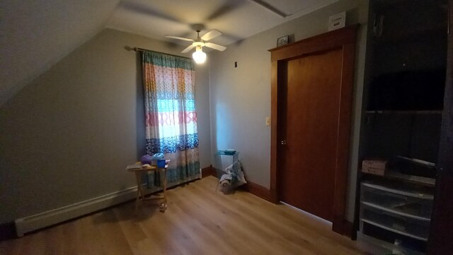 2540 S Dreyer Rd, Au Gres, MI 48703 - unfurnished bedroom with wood finished floors, lofted ceiling, baseboards, and a ceiling fan