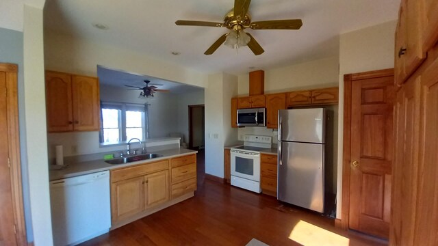 2540 S Dreyer Rd, Au Gres, MI 48703 - kitchen with appliances with stainless steel finishes, a sink, light countertops, dark wood finished floors, and a ceiling fan