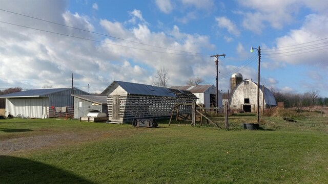 2540 S Dreyer Rd, Au Gres, MI 48703 - rear view of property with a yard and an outbuilding