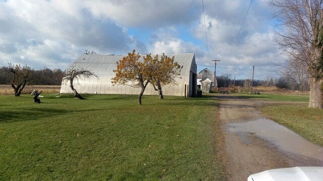 2540 S Dreyer Rd, Au Gres, MI 48703 - view of community with a lawn, dirt driveway, and an outbuilding