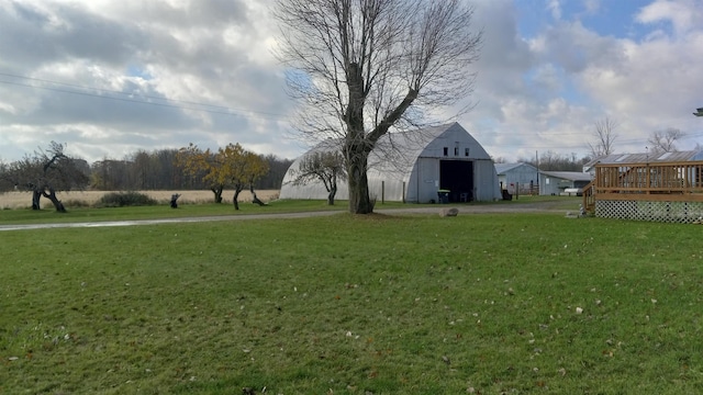 2540 S Dreyer Rd, Au Gres, MI 48703 - view of green lawn with an outbuilding and a wooden deck