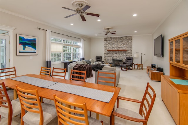 4090 Perryville Rd, Ortonville, MI 48462 - dining area featuring recessed lighting, ceiling fan, crown molding, a fireplace, and light carpet