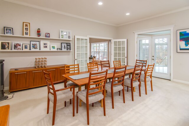 dining room featuring french doors, light colored carpet, and crown molding