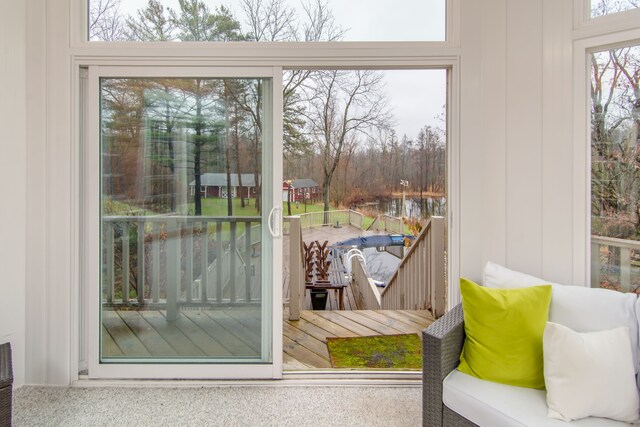 doorway to outside featuring carpet floors