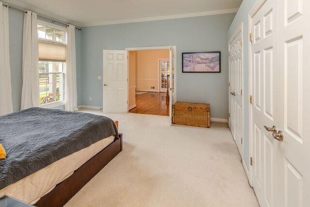 carpeted bedroom featuring crown molding