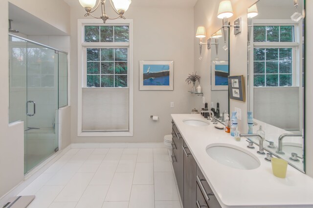 bathroom featuring walk in shower, an inviting chandelier, tile patterned floors, and a wealth of natural light