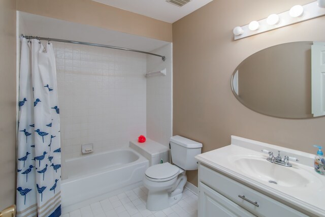 full bathroom with tile patterned floors, shower / bath combo with shower curtain, vanity, and toilet