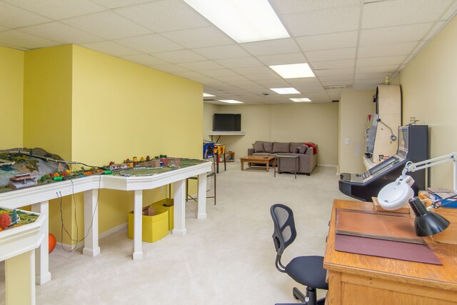 office space featuring a paneled ceiling and light carpet