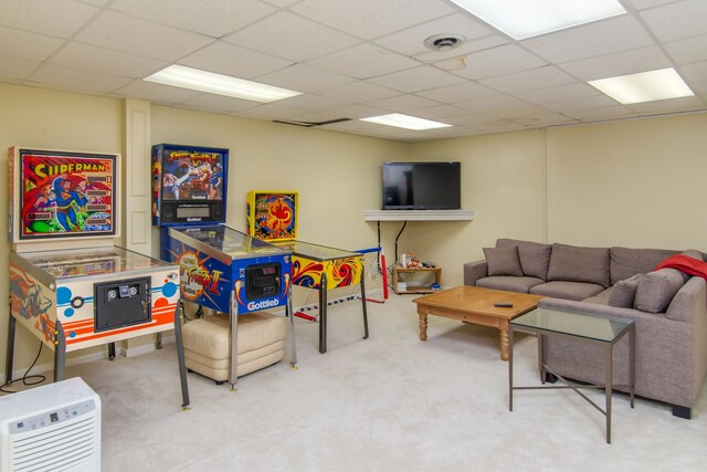 living room featuring a drop ceiling and carpet floors