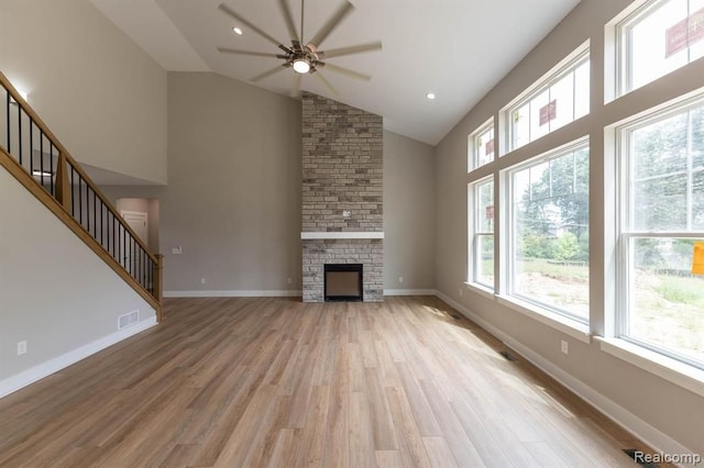 02 Textile, Saline, MI 48176 - unfurnished living room with a ceiling fan, high vaulted ceiling, light wood-type flooring, stairs, and a fireplace