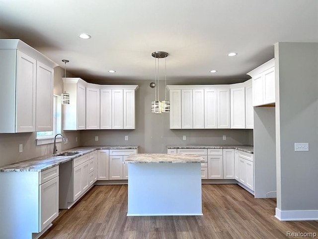 kitchen with white cabinets and hanging light fixtures