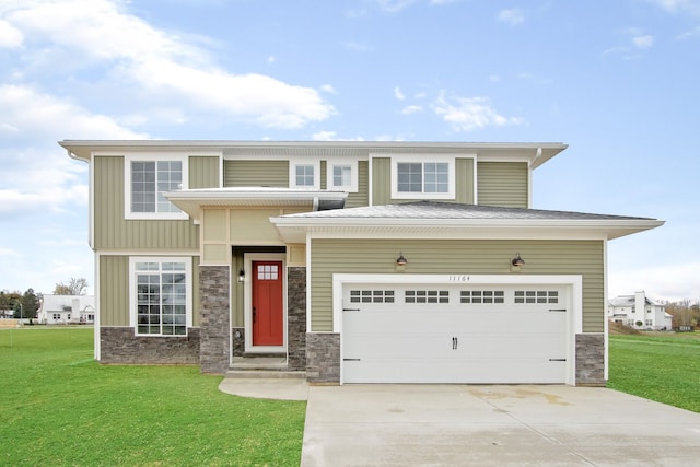 view of front of home featuring a front yard and a garage