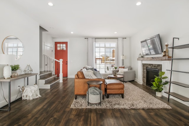 living room featuring a fireplace and dark wood-type flooring