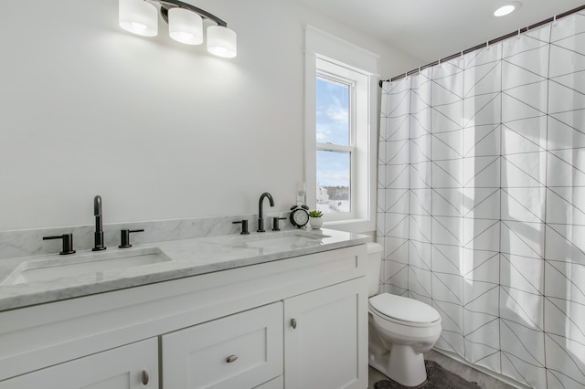 bathroom featuring vanity, toilet, and a wealth of natural light