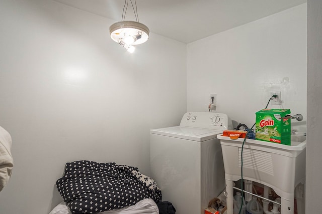 clothes washing area with sink and washer / dryer