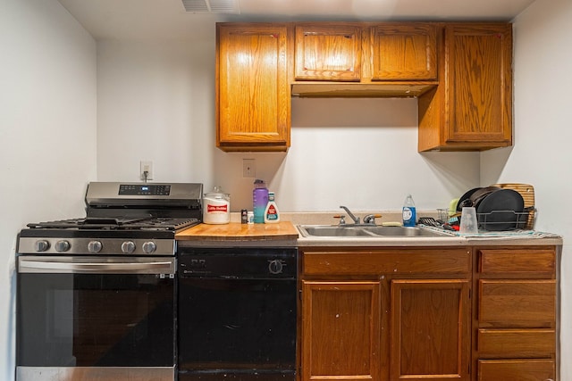 kitchen featuring sink, black dishwasher, and stainless steel range with gas stovetop