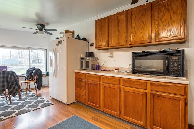 kitchen with ceiling fan, light wood-type flooring, and white refrigerator with ice dispenser