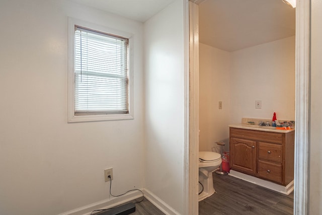 bathroom with hardwood / wood-style floors, vanity, and toilet