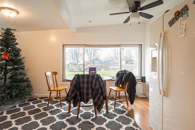 dining room with beam ceiling, ceiling fan, and light hardwood / wood-style flooring