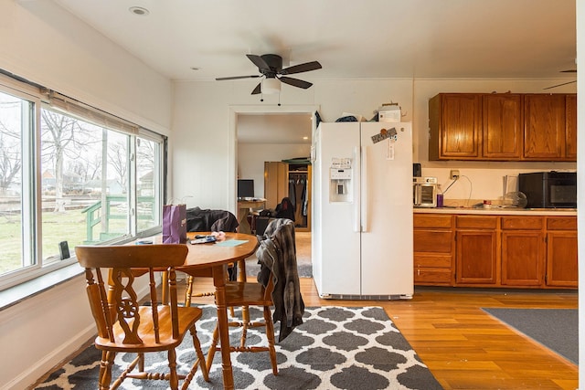 dining area featuring plenty of natural light, ceiling fan, and light wood-type flooring