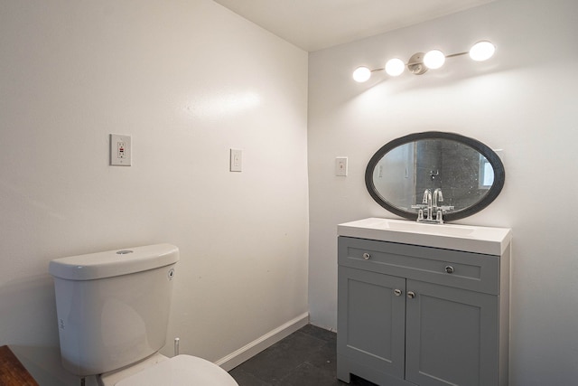 bathroom with tile patterned flooring, vanity, and toilet