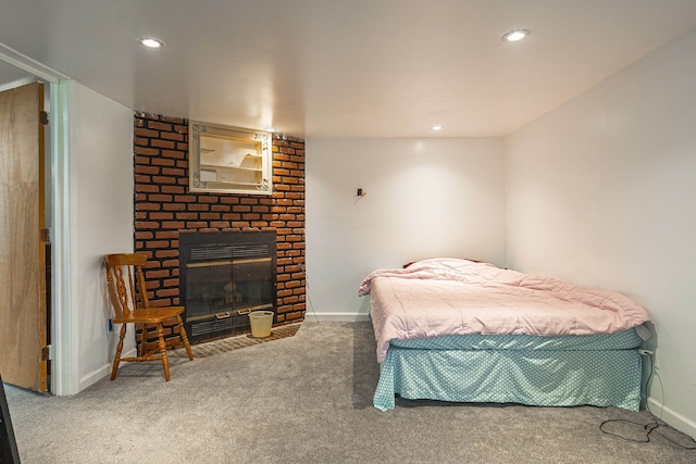 bedroom with carpet flooring and a brick fireplace