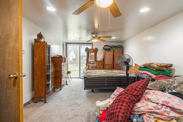 carpeted bedroom with ceiling fan and access to exterior