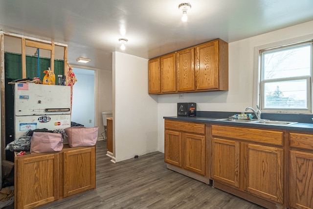 7434 Dyke Rd, Clay, MI 48001 - kitchen with dark countertops, brown cabinetry, and dark wood-style flooring