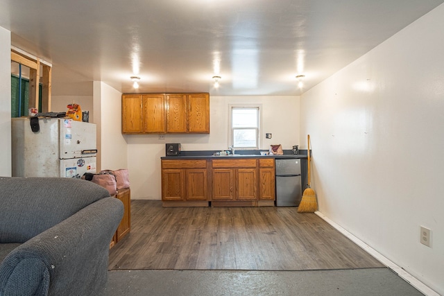 kitchen featuring stainless steel fridge, sink, white fridge, and dark wood-type flooring