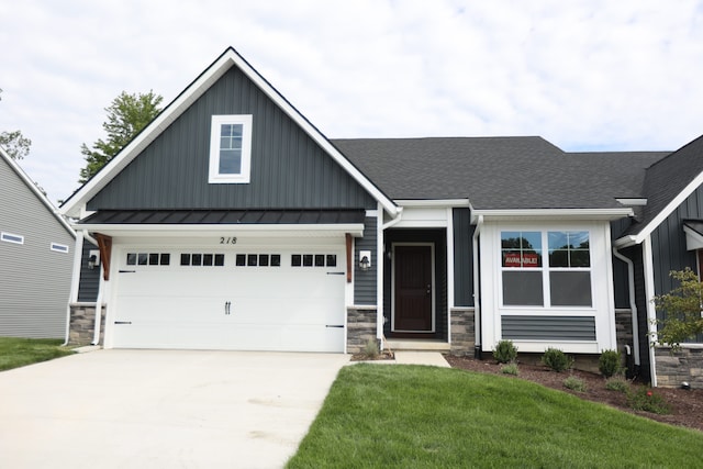 craftsman inspired home featuring a garage and a front yard